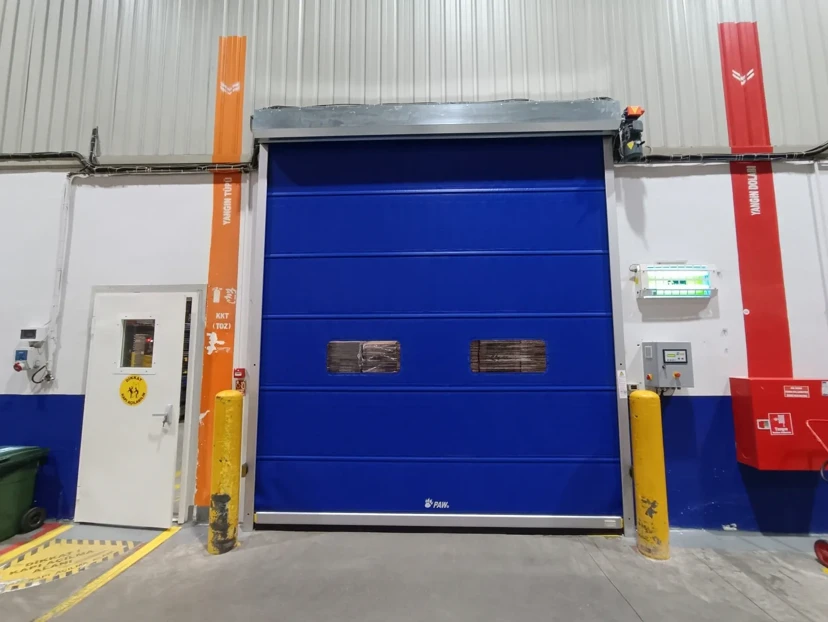 High-Speed Warehouse Roll-Up PVC Door High-speed roll-up PVC door in a warehouse