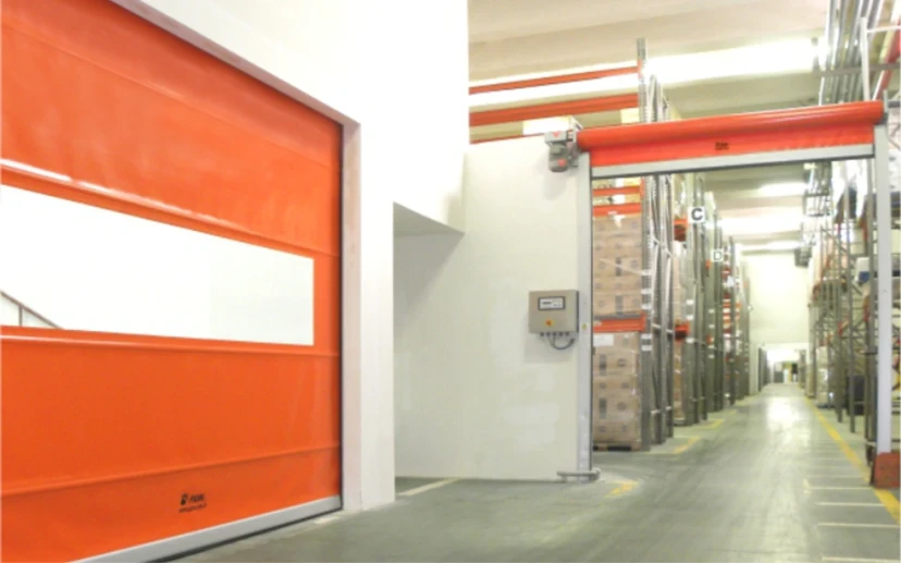 Orange Rapid Warehouse Roll-Up Door Orange rapid roll-up door in a warehouse